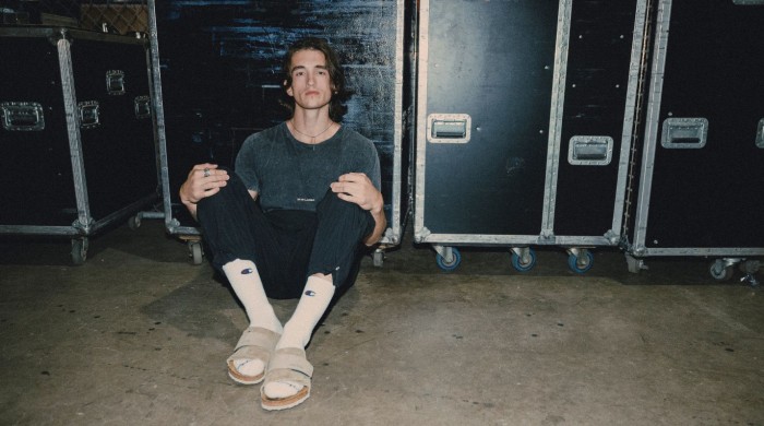 Chance Pena sat in front of some flight cases